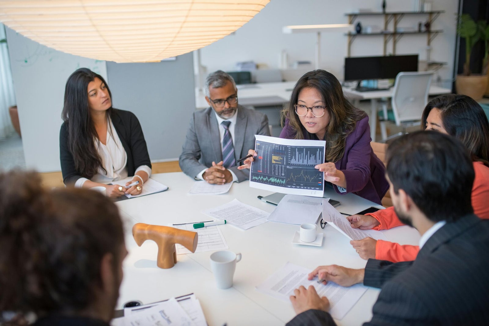 Finance professionals reviewing analysis in a business meeting
